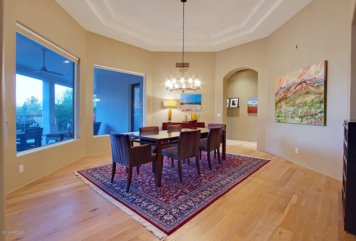 4805 East Pebble Ridge Road Paradise Valley, AZ 85253 - Photo 30 of 37 a view of a dining room with furniture window and wooden floor