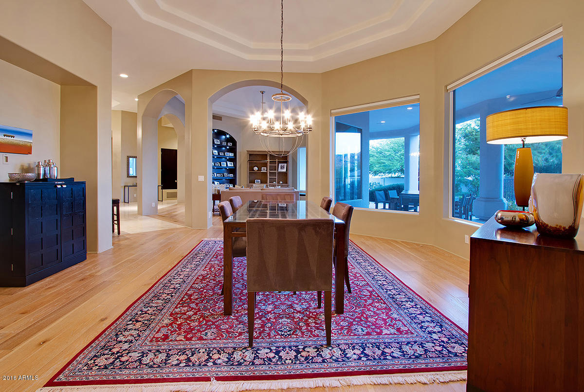 4805 East Pebble Ridge Road Paradise Valley, AZ 85253 - Photo 7 of 37 a living room with furniture a rug and a chandelier