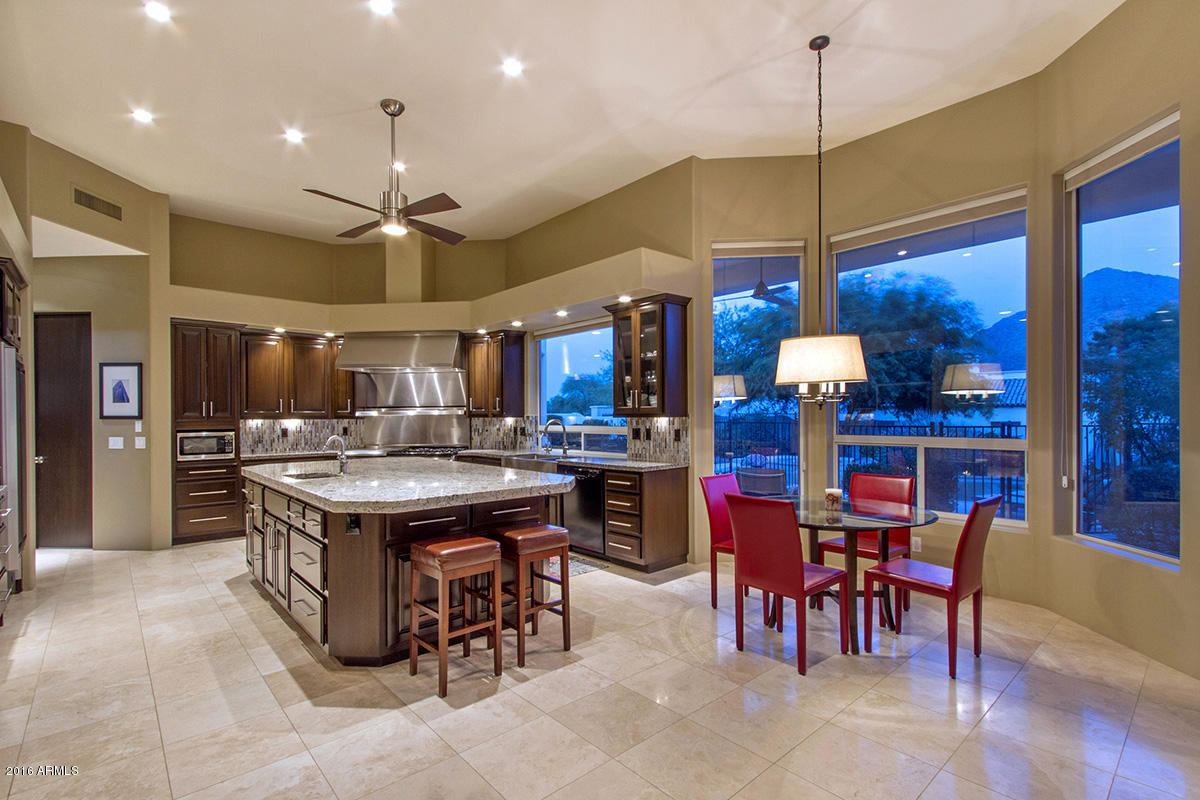 4805 East Pebble Ridge Road Paradise Valley, AZ 85253 - Photo 9 of 37 a kitchen with a table and chairs in it