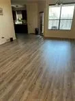 a view of a room with wooden floor and windows