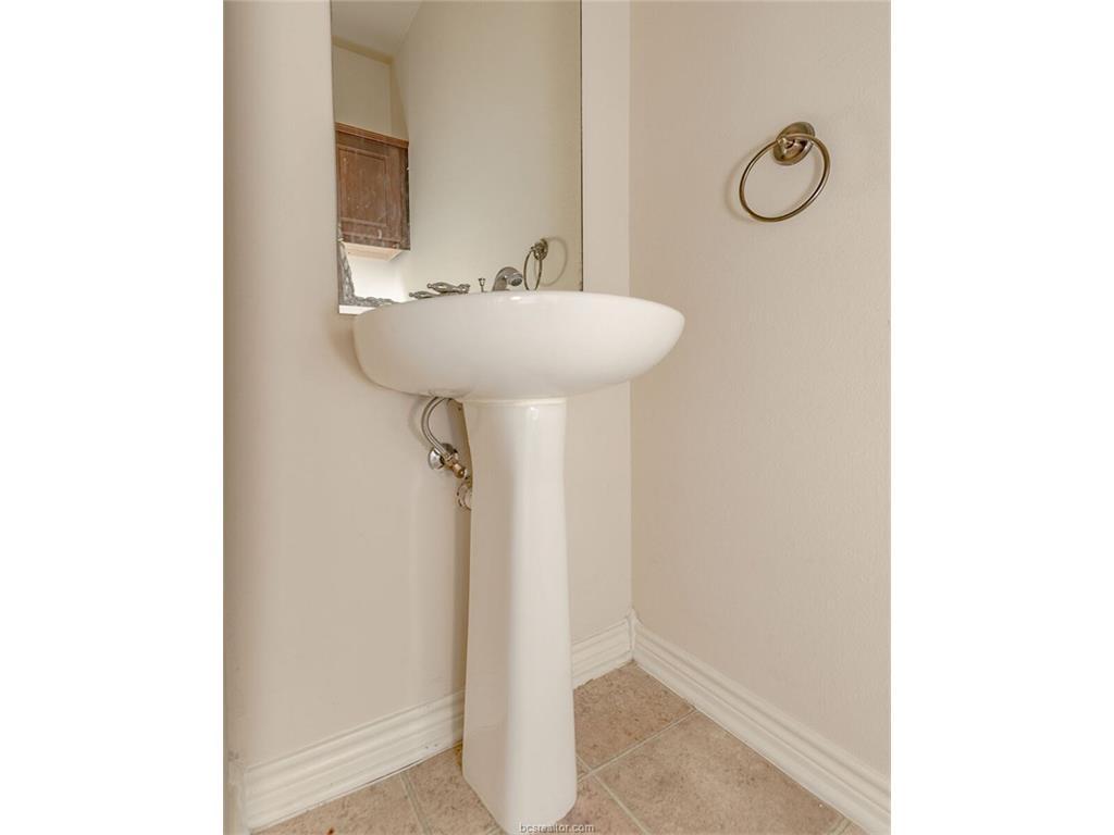1425 West Villa Maria Road, Unit 602 Bryan, TX 77801 - Photo 9 of 12 a bathroom with a sink and a mirror