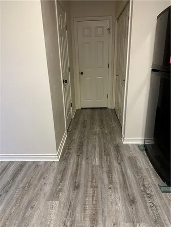a view of a room with wooden floor and a sink