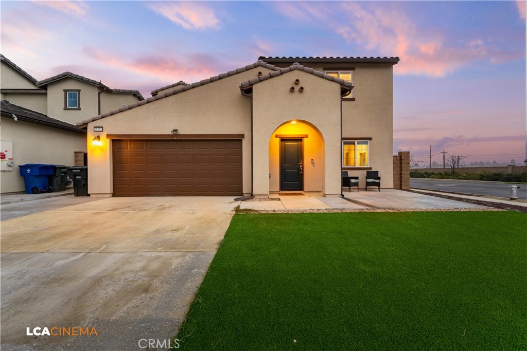 a front view of a house with a garden
