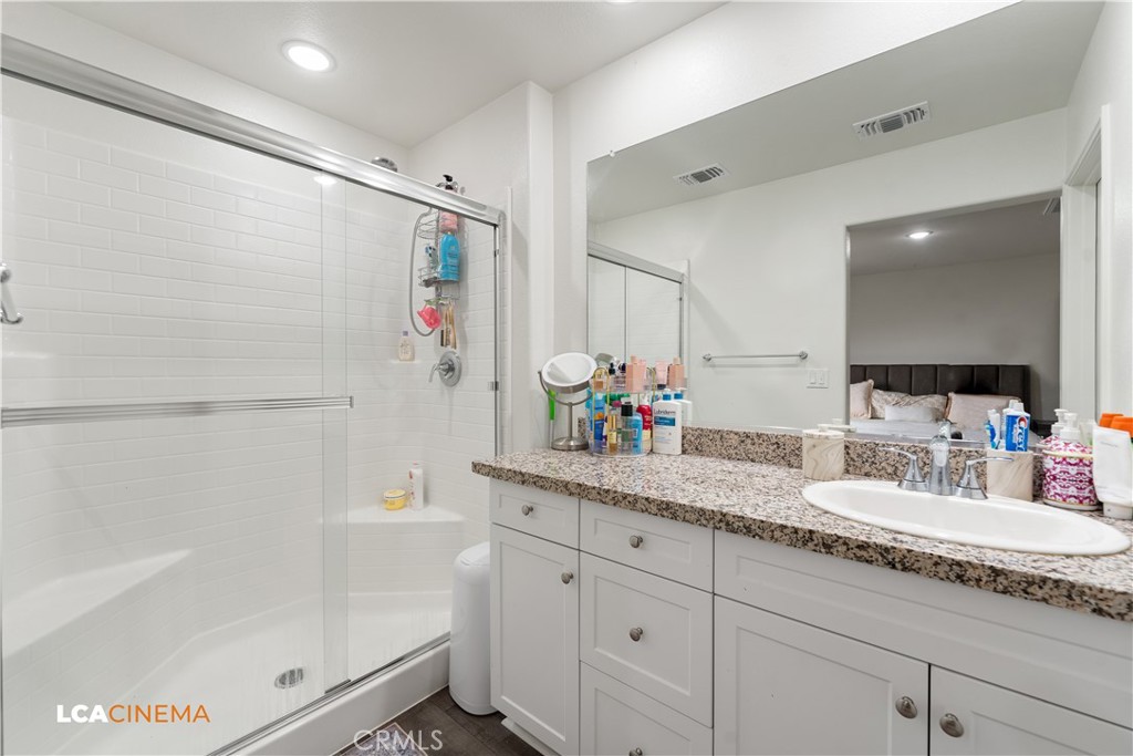 11112 Pasto Way Bakersfield, CA 93306 - Photo 15 of 35 a bathroom with a granite countertop sink mirror bathtub and shower
