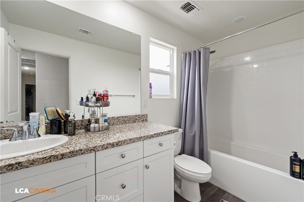 11112 Pasto Way Bakersfield, CA 93306 - Photo 16 of 35 a bathroom with a granite countertop toilet sink and mirror