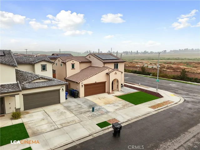 a view of a patio with lawn chairs next to an ocean