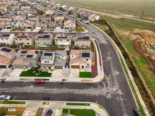 an aerial view of a residential houses with outdoor space