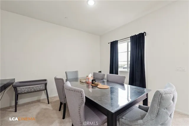 a view of a dining room with furniture and window