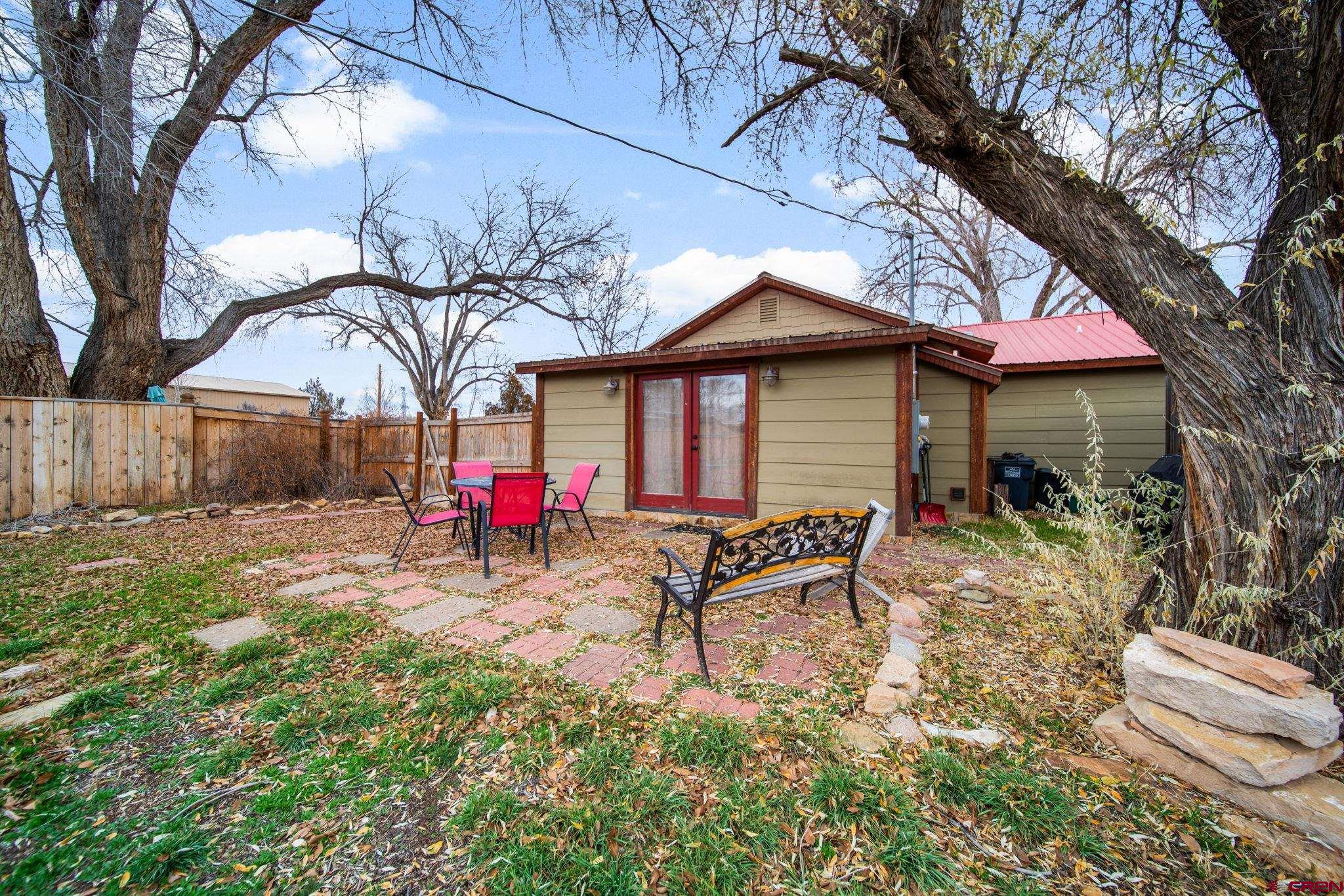 115 South Linden Street Cortez, CO 81321 - Photo 22 of 30 a view of backyard with table and chairs and a fire pit
