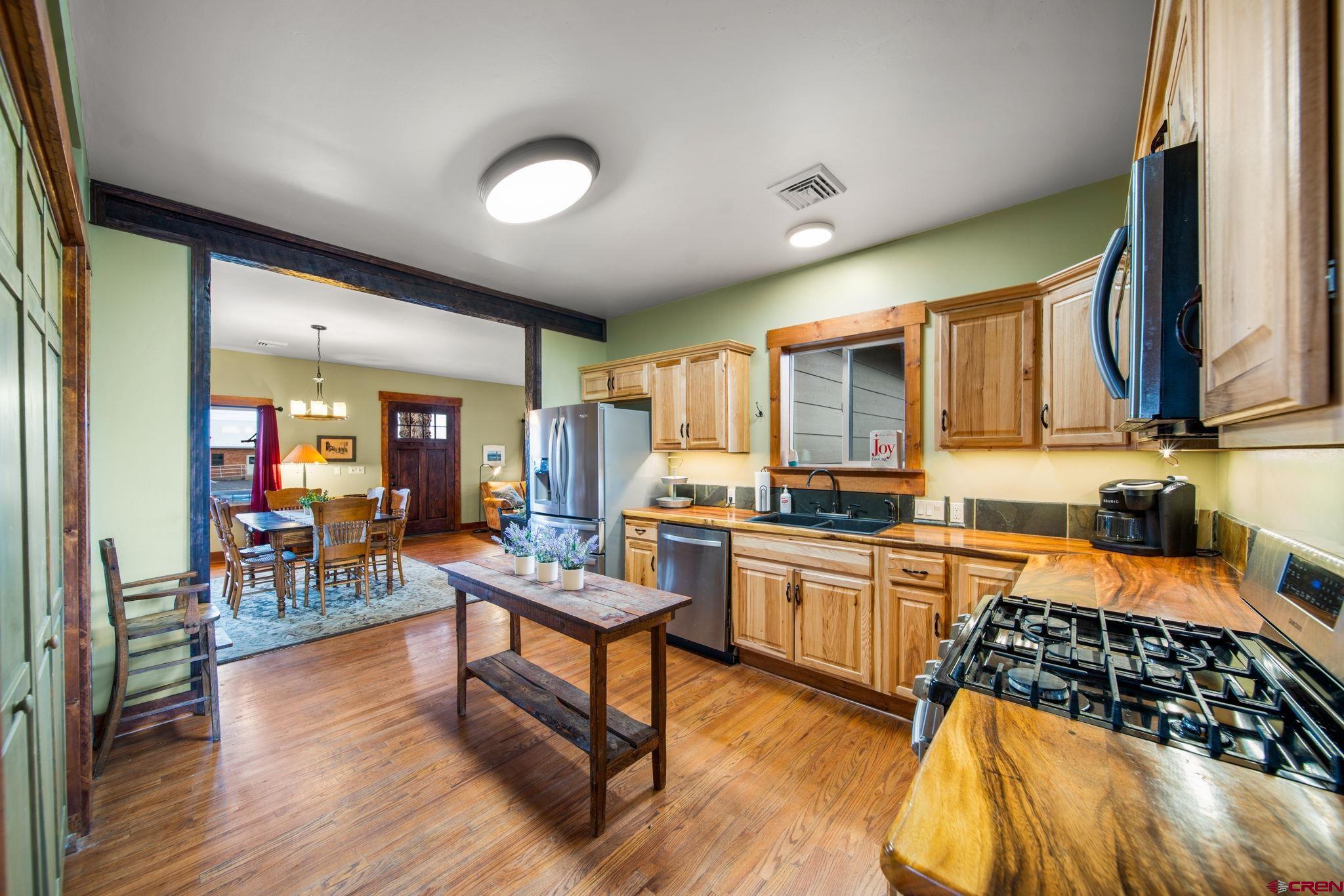 115 South Linden Street Cortez, CO 81321 - Photo 9 of 30 a kitchen with granite countertop a stove a sink and a refrigerator