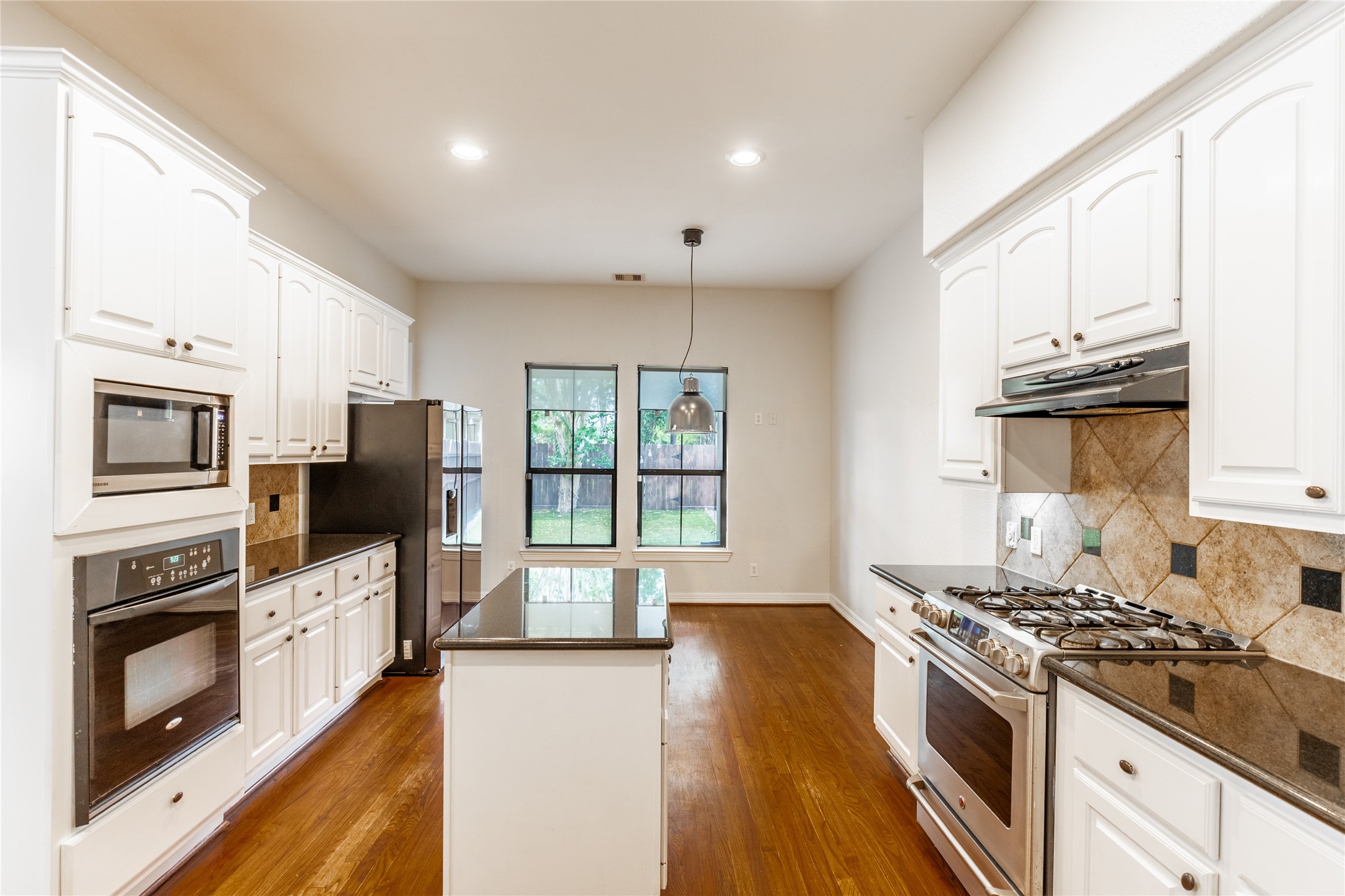 2923 Royal Oaks Crest Houston, TX 77082 - Photo 10 of 31 a large kitchen with stainless steel appliances granite countertop a stove and a refrigerator