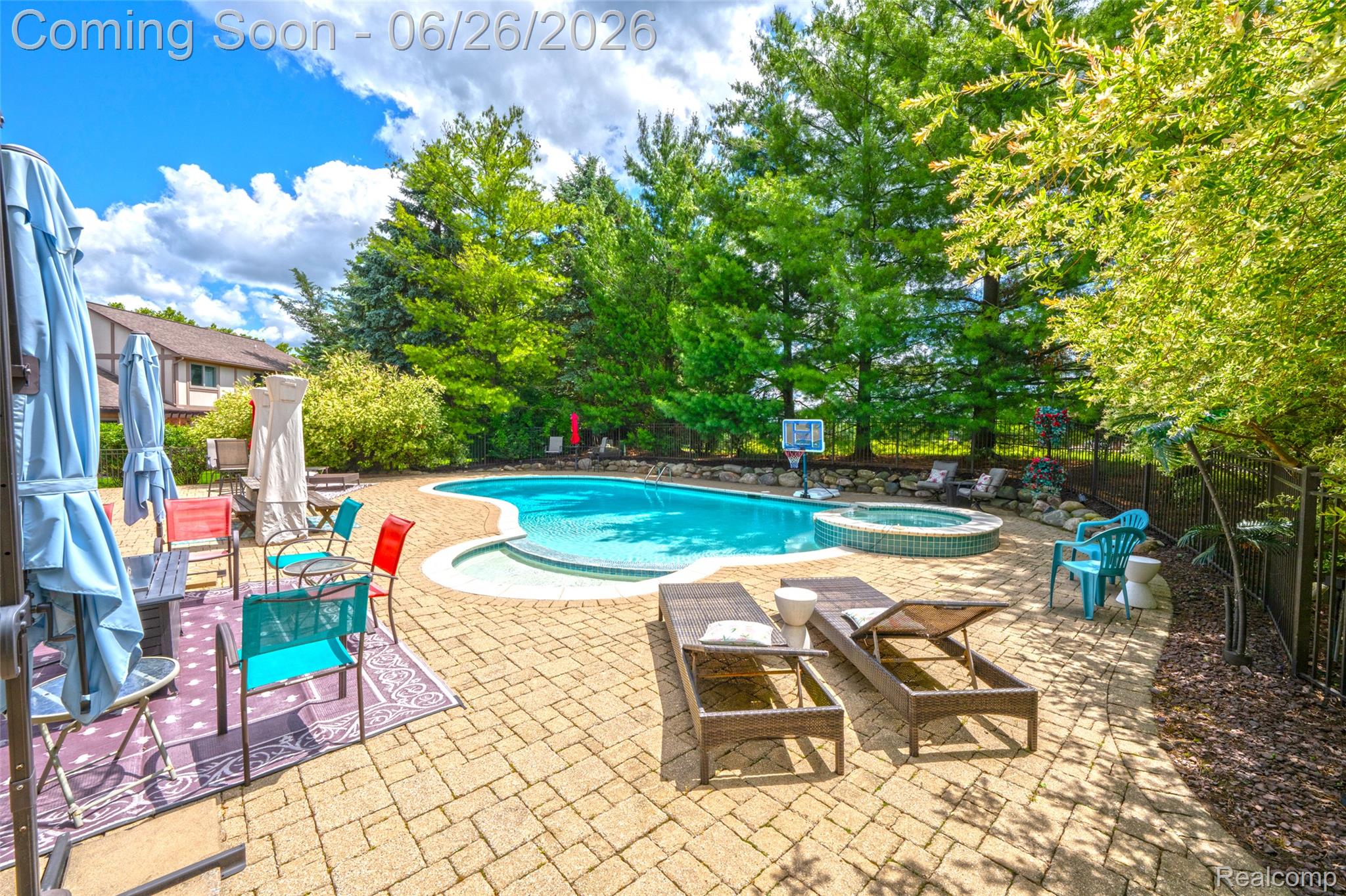 2619 Lambeth Park Rochester, MI 48306 - Photo 6 of 71 Expansive paver patio surrounding a freeform pool with an integrated spa