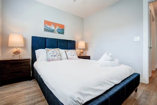 a bedroom with bed and lamp