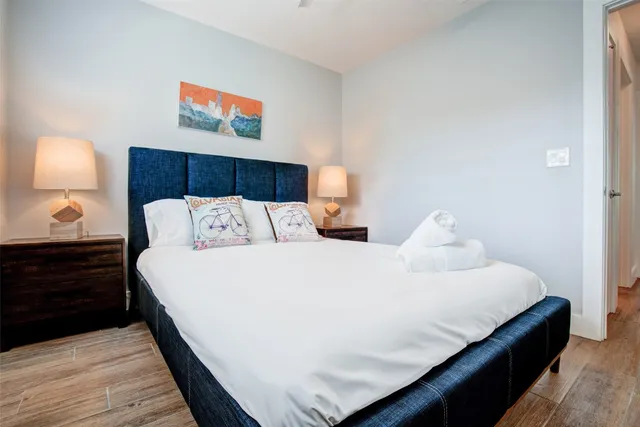 a bedroom with bed and lamp