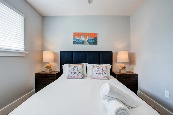 a bedroom with a bed and a night stand