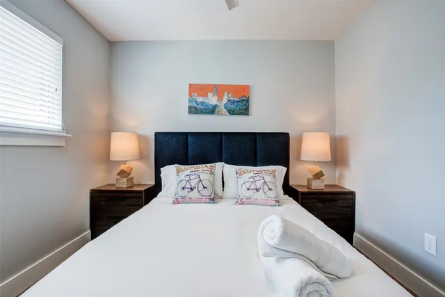 a bedroom with a bed and a night stand