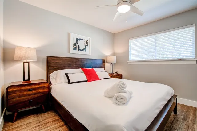 a bedroom with a bed and a lamp