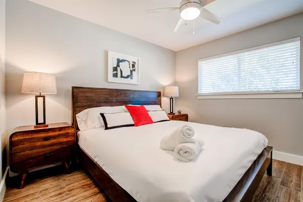 a bedroom with a bed and a lamp