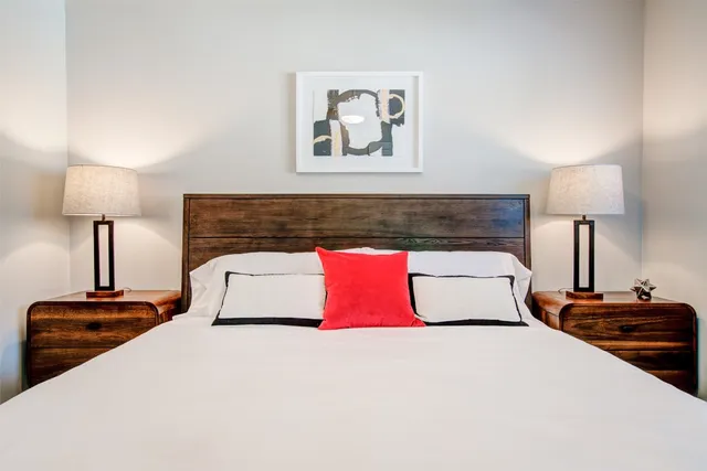 a bedroom with a bed and a lamp