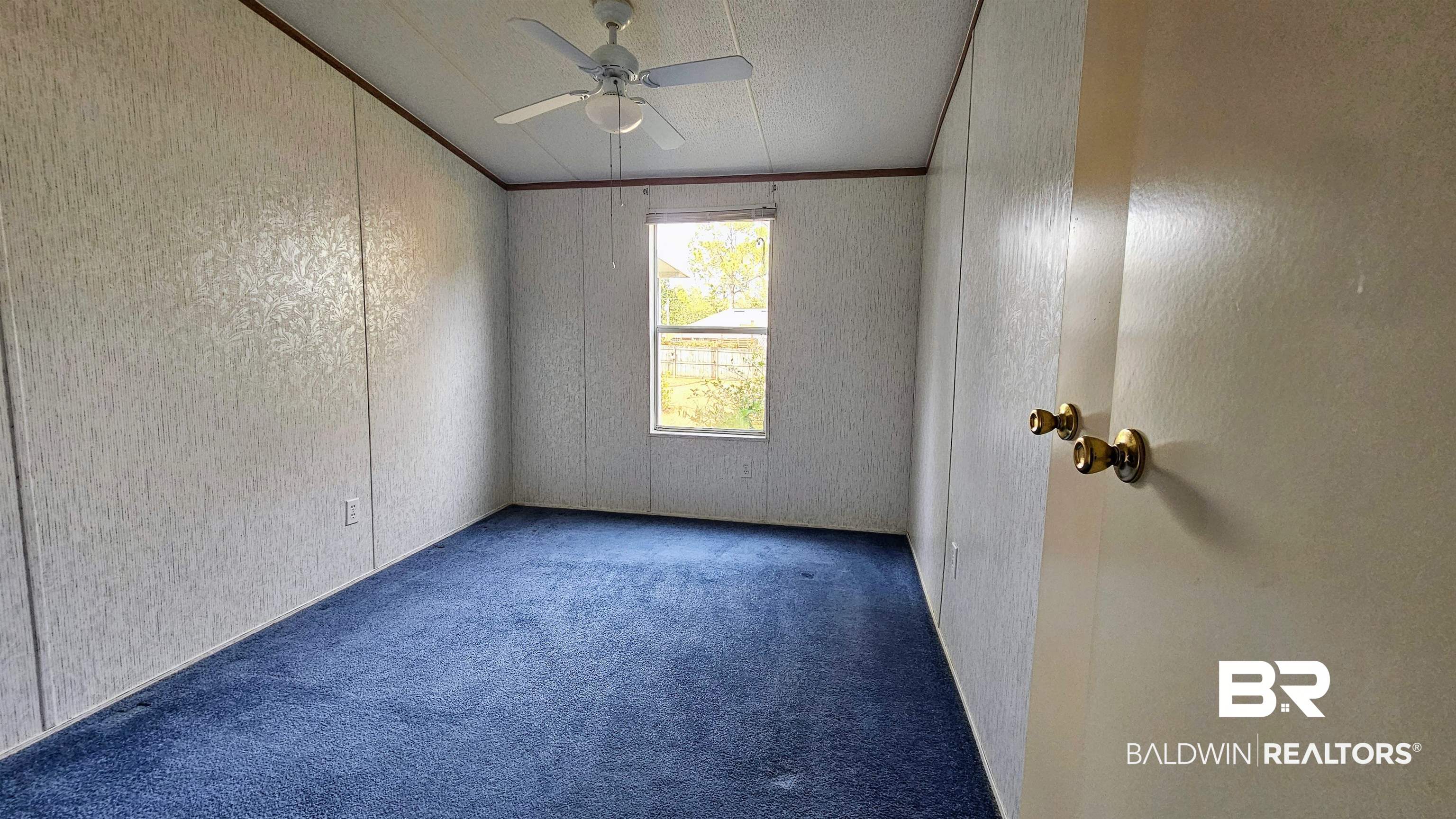 18659 Bull Springs Road Robertsdale, AL 36567 - Photo 20 of 25 Carpeted spare room featuring crown molding and ceiling fan