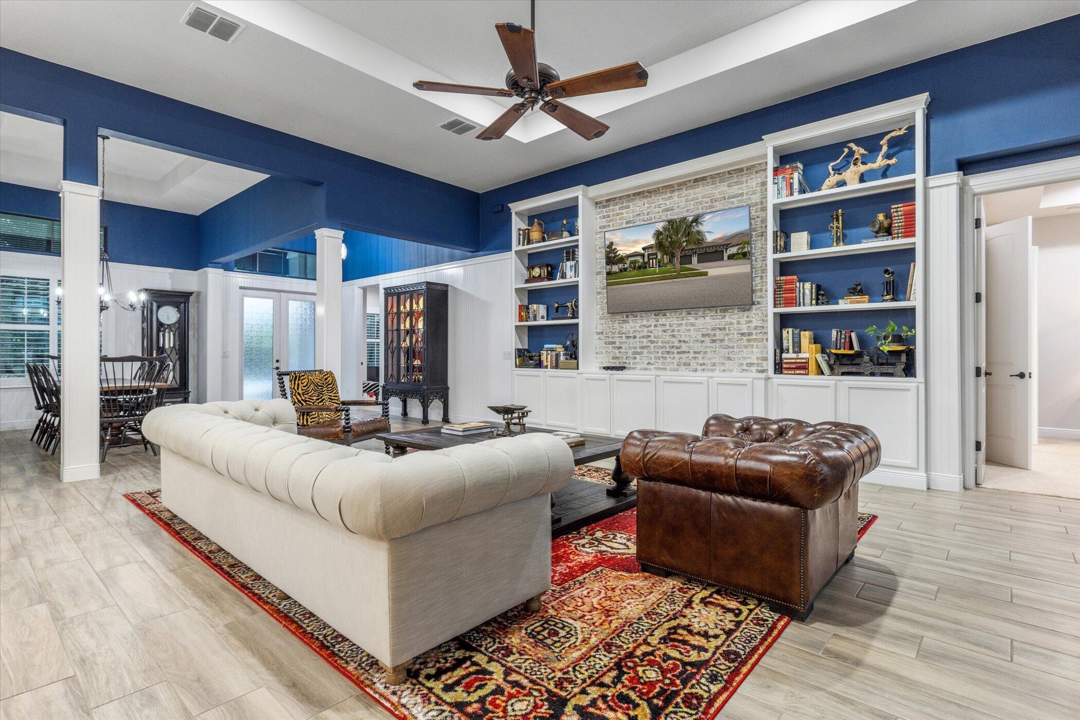 5420 Calder Drive Melbourne, FL 32940 - Photo 22 of 73 a living room with furniture a rug and a bookshelf