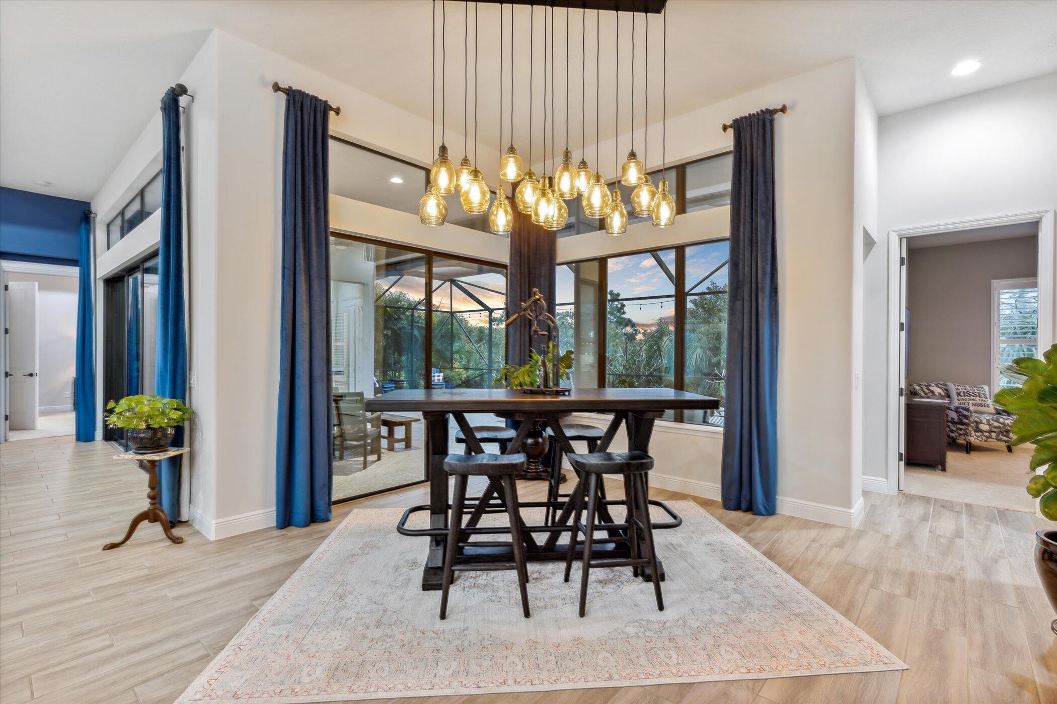 5420 Calder Drive Melbourne, FL 32940 - Photo 32 of 73 a view of a dining room with furniture a chandelier and wooden floor