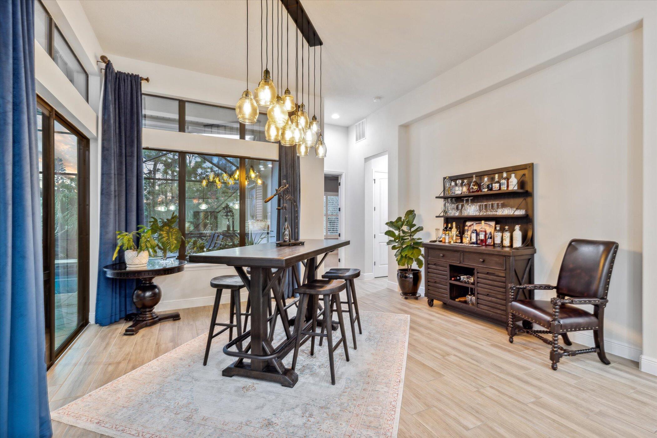 5420 Calder Drive Melbourne, FL 32940 - Photo 33 of 73 a view of a dining room with furniture a chandelier and wooden floor