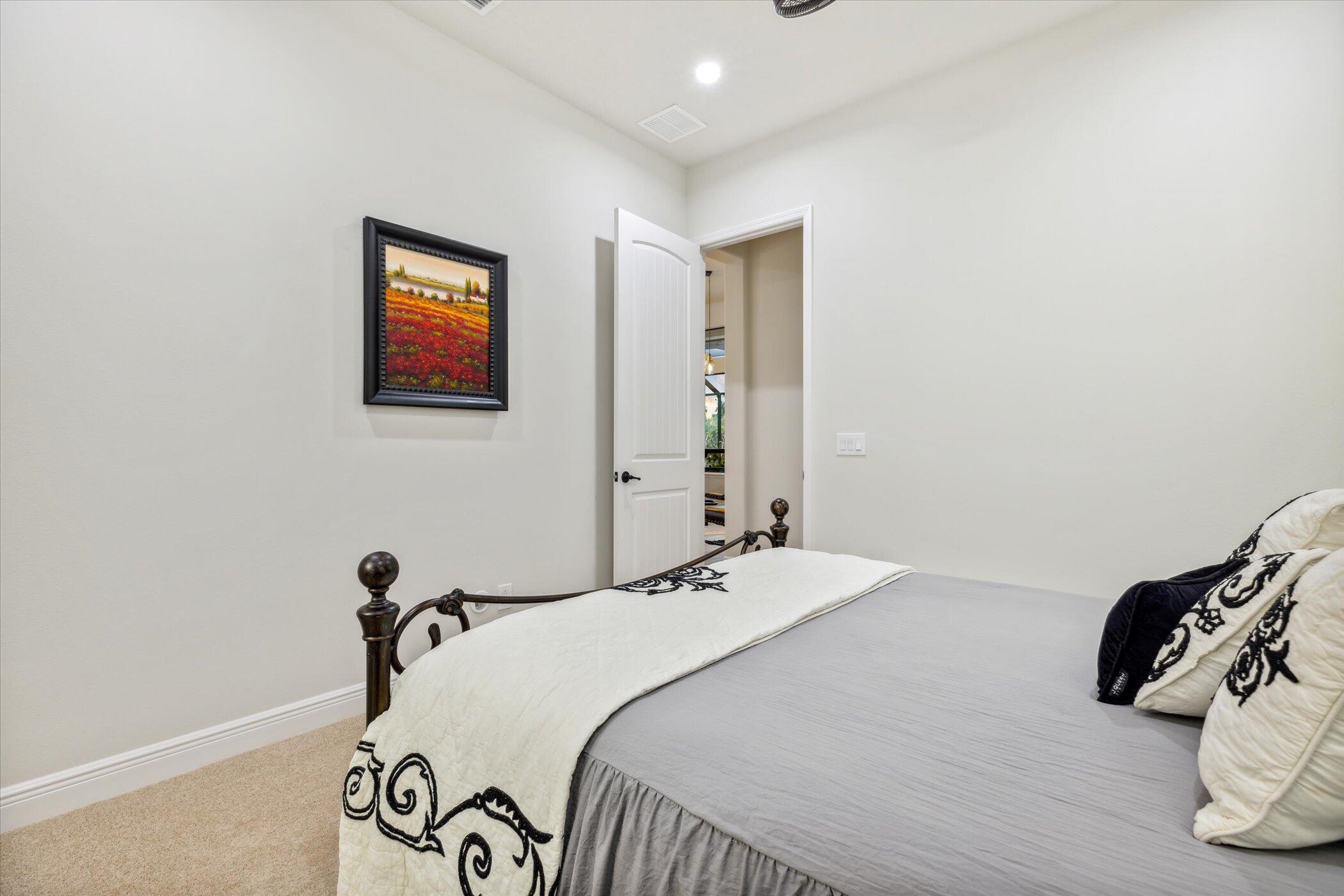 5420 Calder Drive Melbourne, FL 32940 - Photo 37 of 73 a bedroom with a bed and a painting on the wall