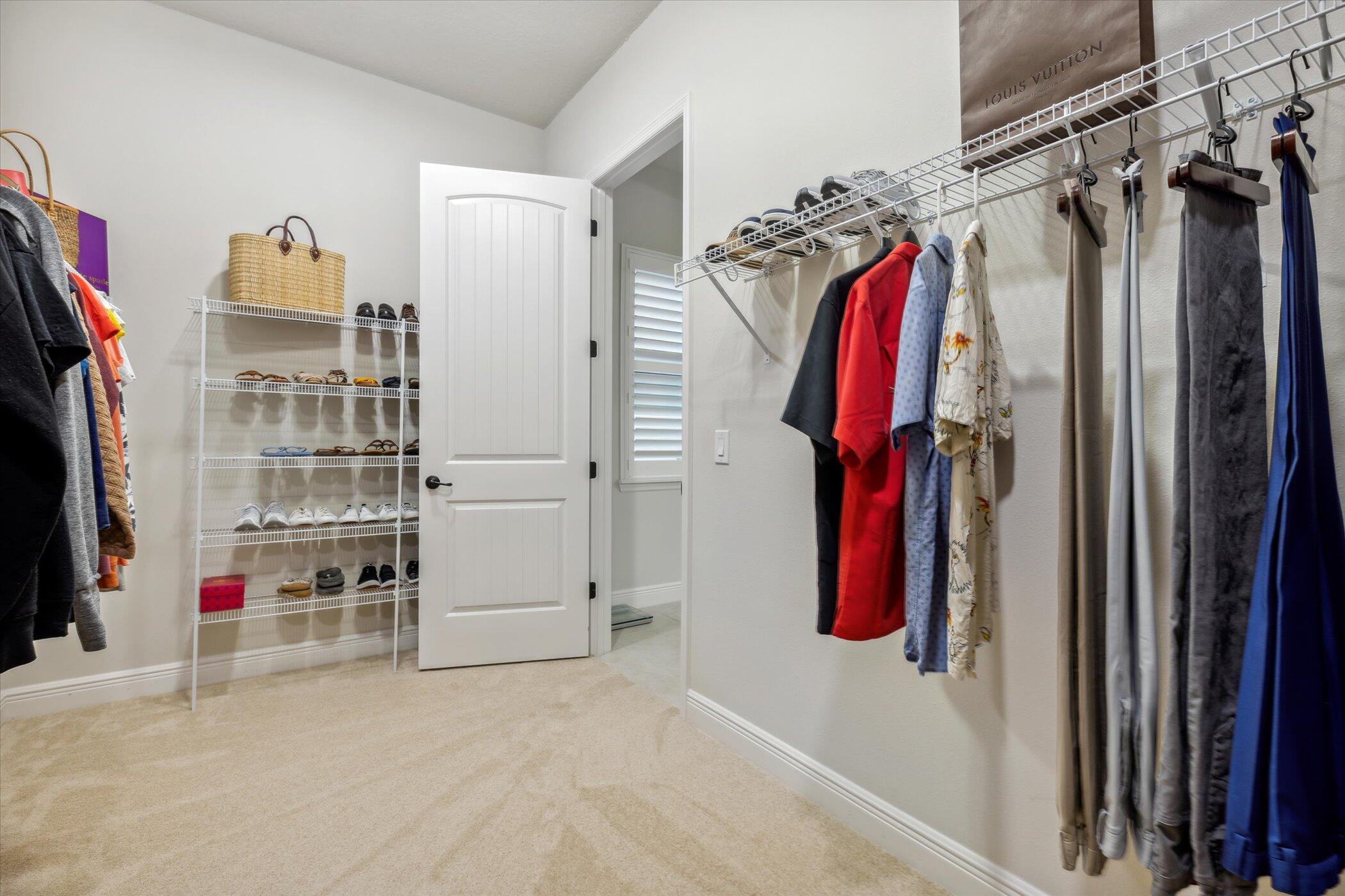 5420 Calder Drive Melbourne, FL 32940 - Photo 41 of 73 a view of walk in closet with clothes and shoes