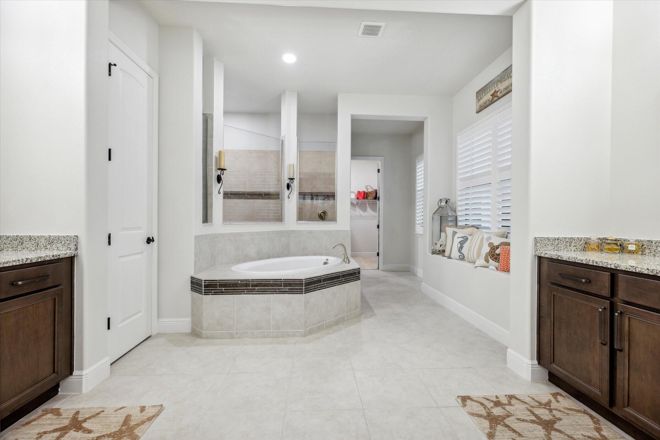 5420 Calder Drive Melbourne, FL 32940 - Photo 47 of 73 a bathroom with a granite countertop bathtub shower sink and mirror