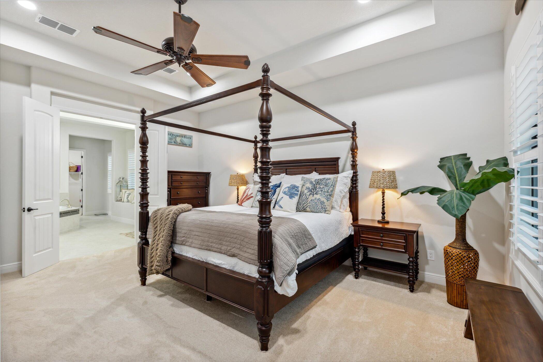 5420 Calder Drive Melbourne, FL 32940 - Photo 49 of 73 a bedroom with a bed lamp and a potted plant