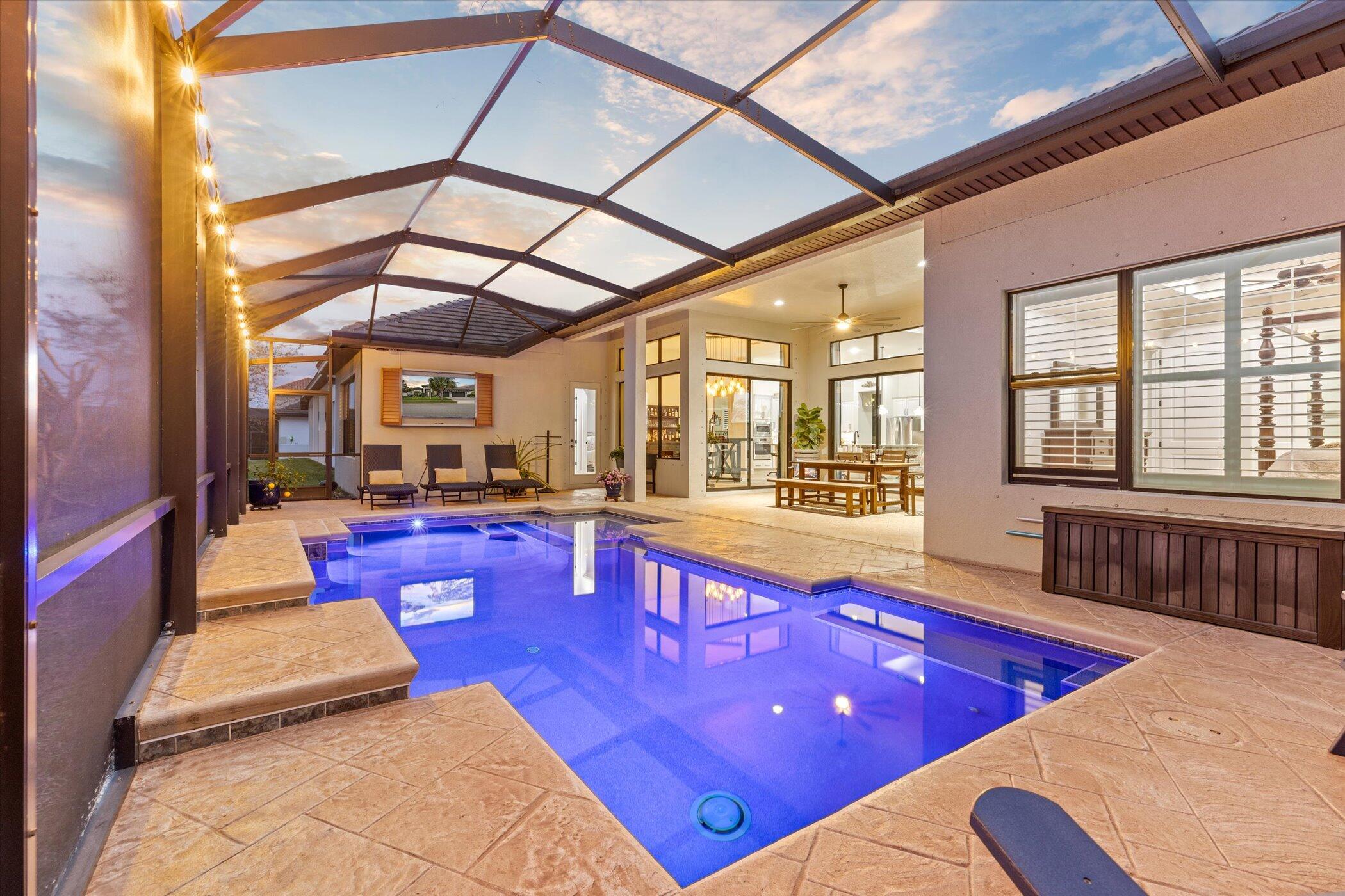 5420 Calder Drive Melbourne, FL 32940 - Photo 59 of 73 a large swimming pool with lawn chairs and wooden floor