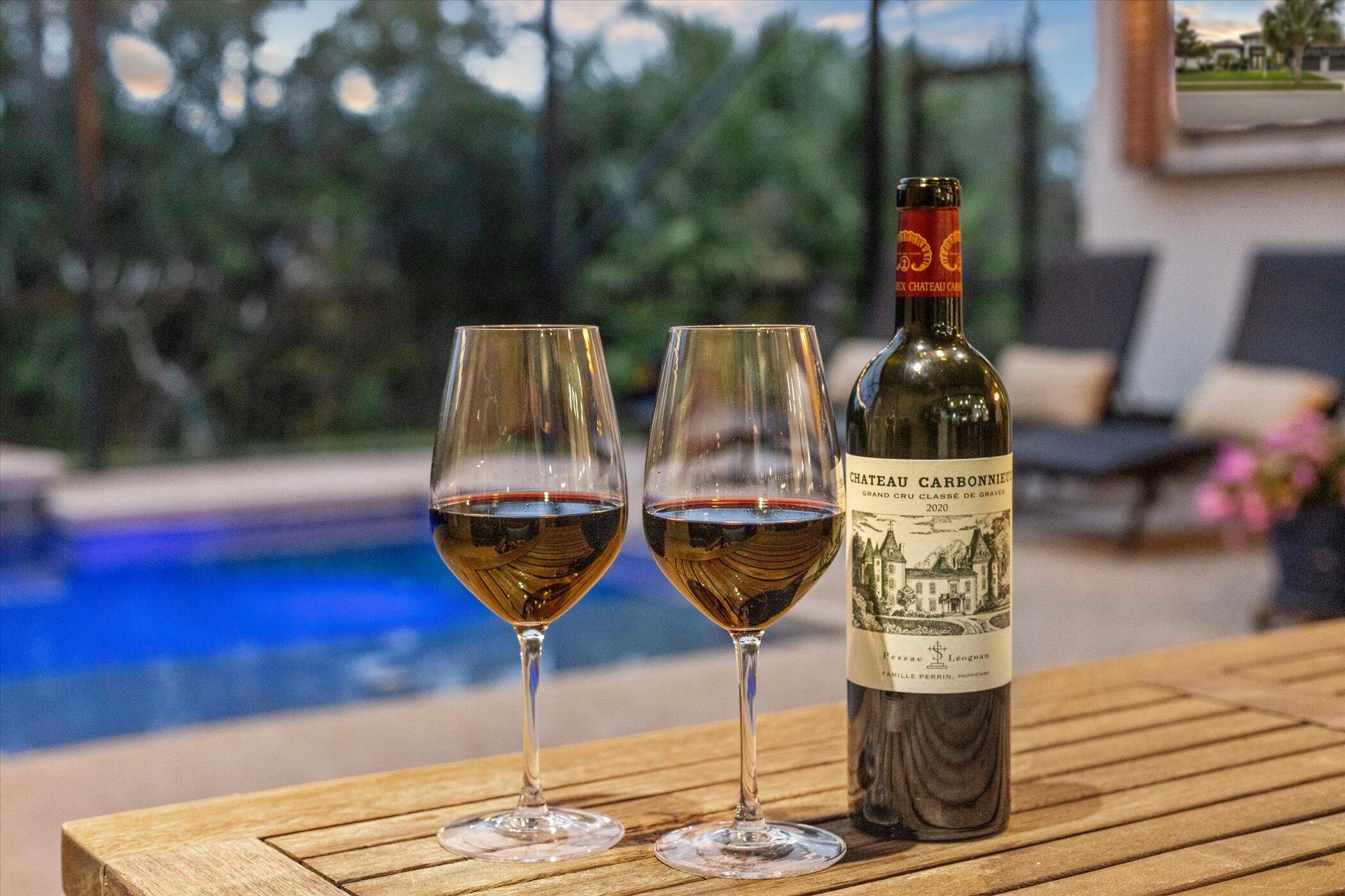 5420 Calder Drive Melbourne, FL 32940 - Photo 8 of 73 a bottle of wine and a glass of wine sitting near a fire pit