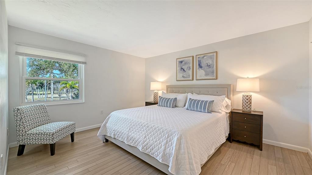 3201 South Beneva Road, Unit 204 Sarasota, FL 34232 - Photo 15 of 34 a bedroom with a bed a lamp and a large window