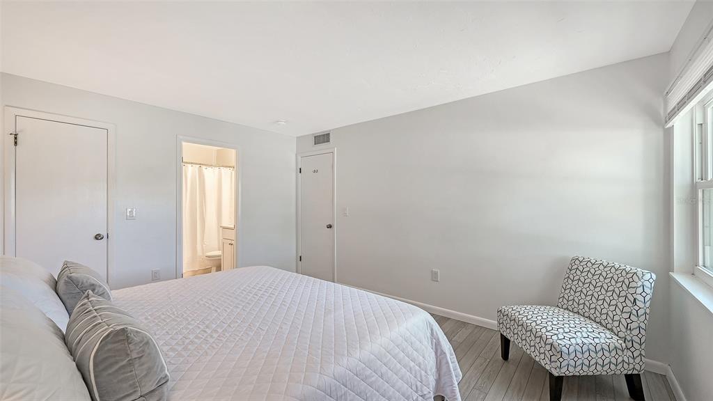 3201 South Beneva Road, Unit 204 Sarasota, FL 34232 - Photo 16 of 34 a bedroom with a bed and a chair