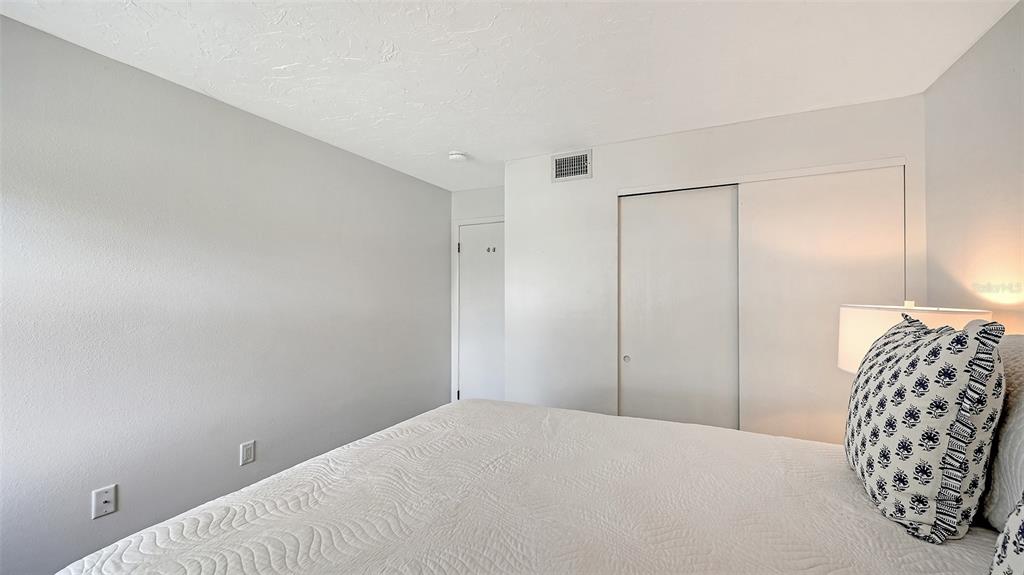 3201 South Beneva Road, Unit 204 Sarasota, FL 34232 - Photo 20 of 34 a bedroom with a bed and a chair