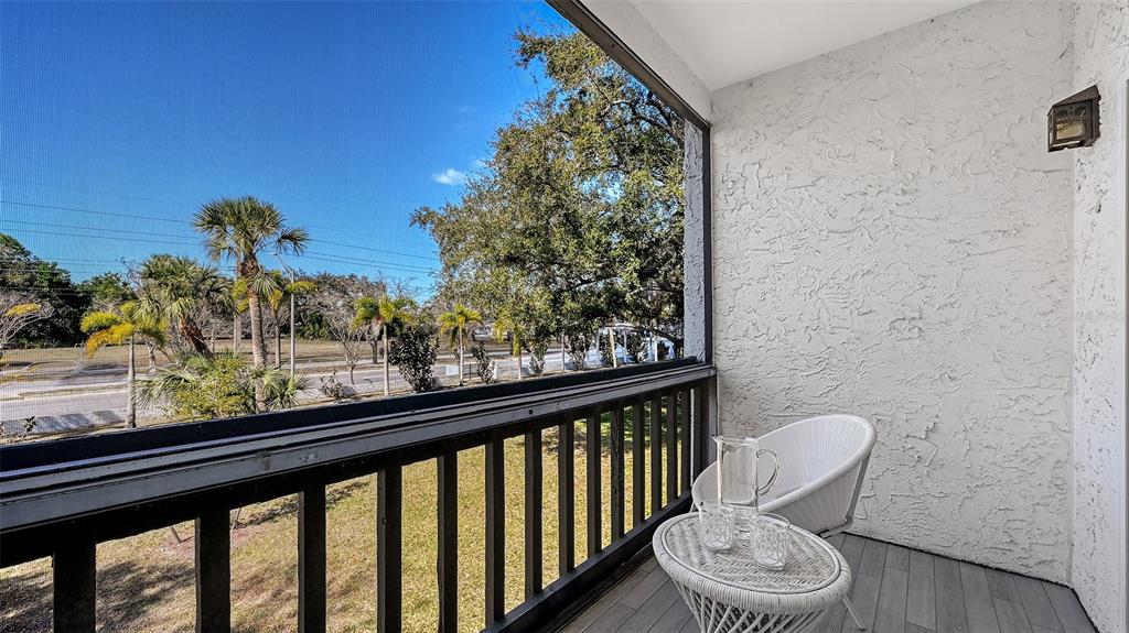 3201 South Beneva Road, Unit 204 Sarasota, FL 34232 - Photo 6 of 34 a view of a porch with furniture and a yard