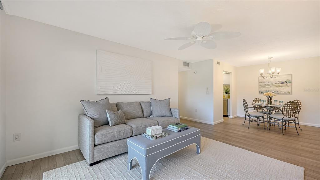 3201 South Beneva Road, Unit 204 Sarasota, FL 34232 - Photo 7 of 34 a living room with furniture and a wooden floor