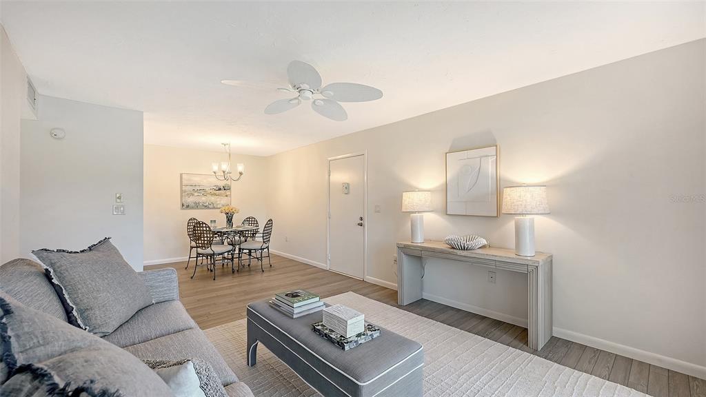 3201 South Beneva Road, Unit 204 Sarasota, FL 34232 - Photo 8 of 34 a living room with furniture and a table