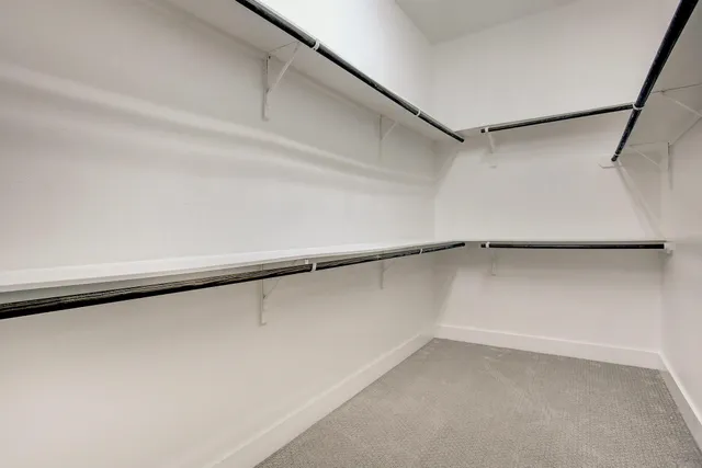 a living room with furniture kitchen view and a flat screen tv