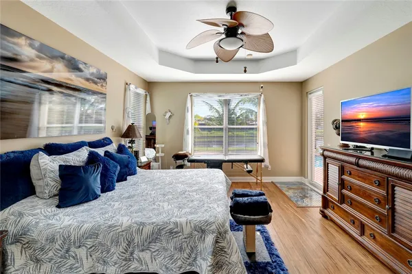 a large bedroom with bed tv and window