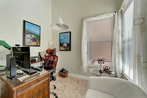 a view of a workspace with furniture and a window