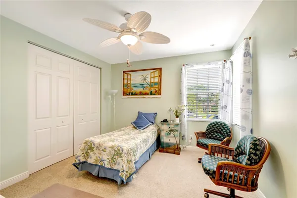 a spacious bedroom with a bed and a window