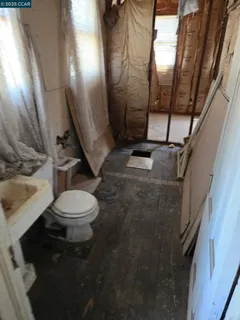 a bathroom with a toilet and a shower