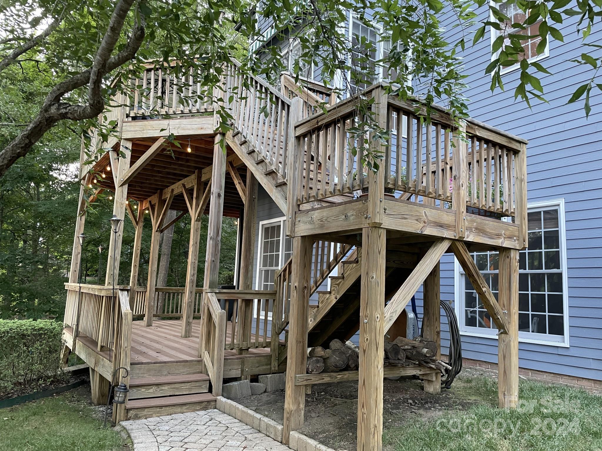 936 Rocky Point Lane Tega Cay, SC 29708 - Photo 11 of 48 a view of wooden house with a small deck and a large tree
