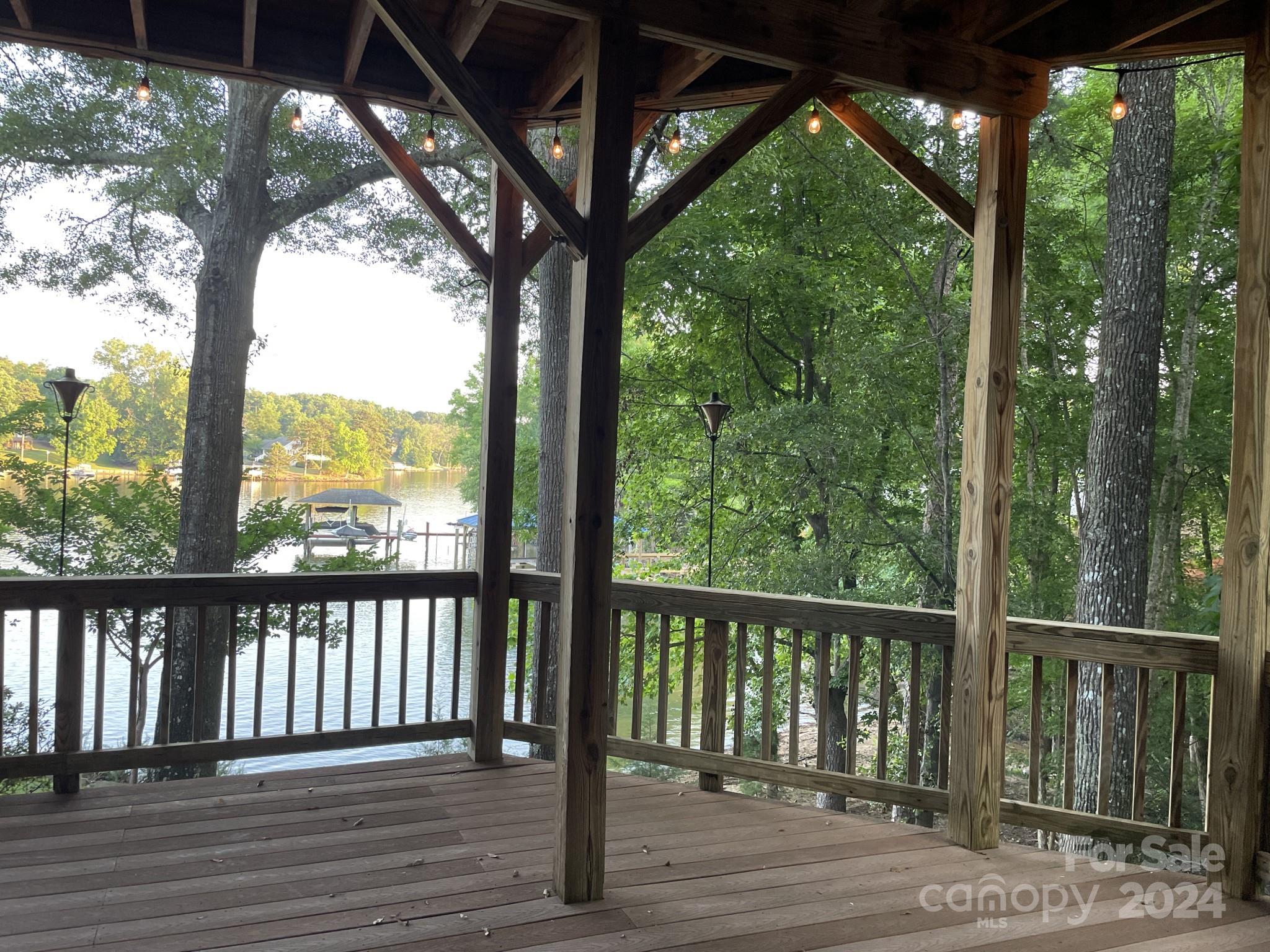 936 Rocky Point Lane Tega Cay, SC 29708 - Photo 14 of 48 a view of a wooden deck next to a yard