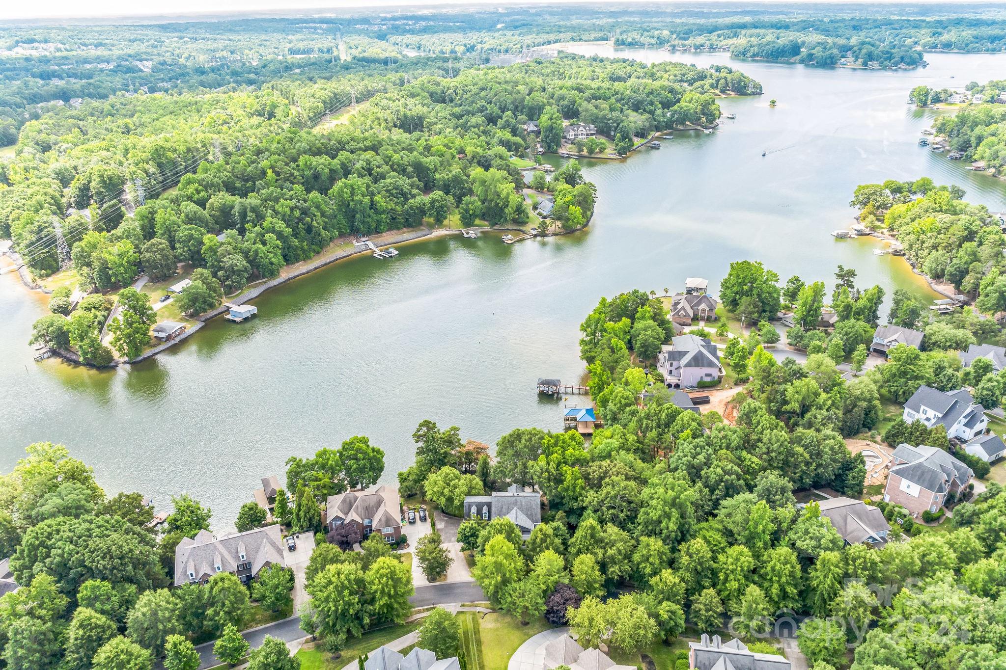 936 Rocky Point Lane Tega Cay, SC 29708 - Photo 2 of 48 a view of a lake with a flower garden