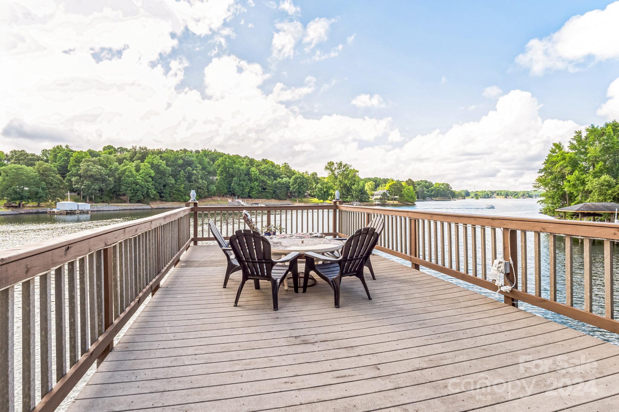 936 Rocky Point Lane Tega Cay, SC 29708 - Photo 25 of 48 a view of deck with table and chairs and wooden floor
