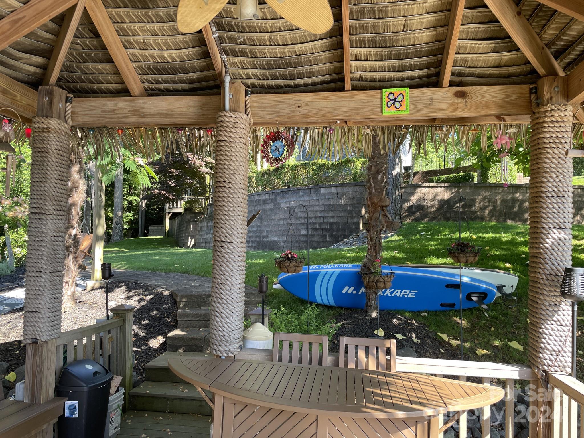 936 Rocky Point Lane Tega Cay, SC 29708 - Photo 27 of 48 a view of patio with table and chairs potted plants