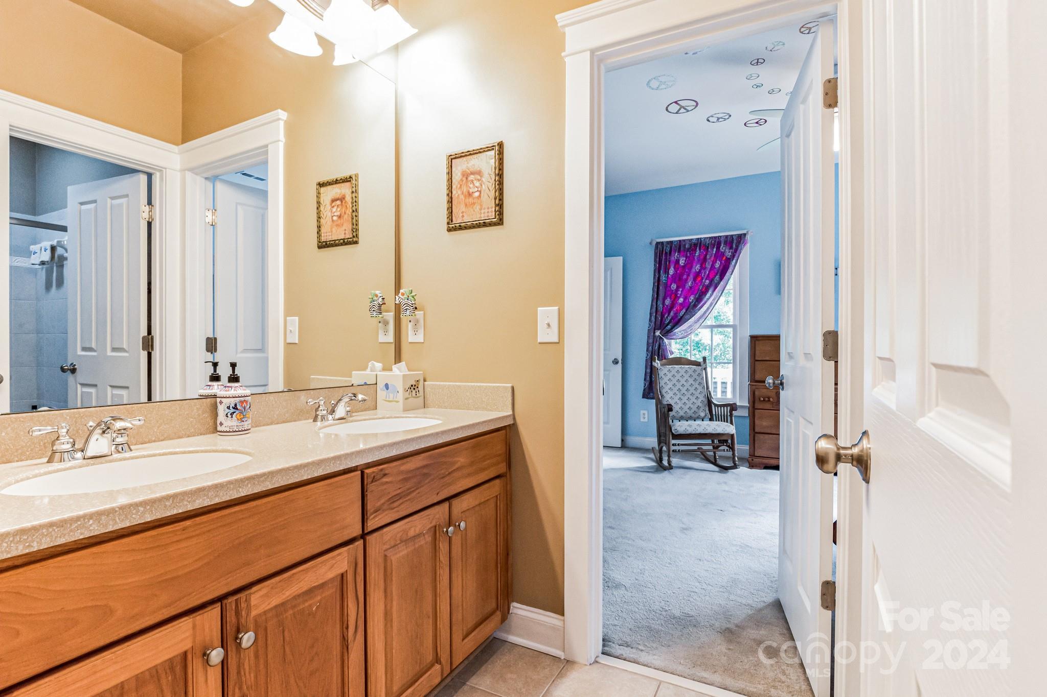 936 Rocky Point Lane Tega Cay, SC 29708 - Photo 36 of 48 a en suite bathroom with a sink a mirror and a shower